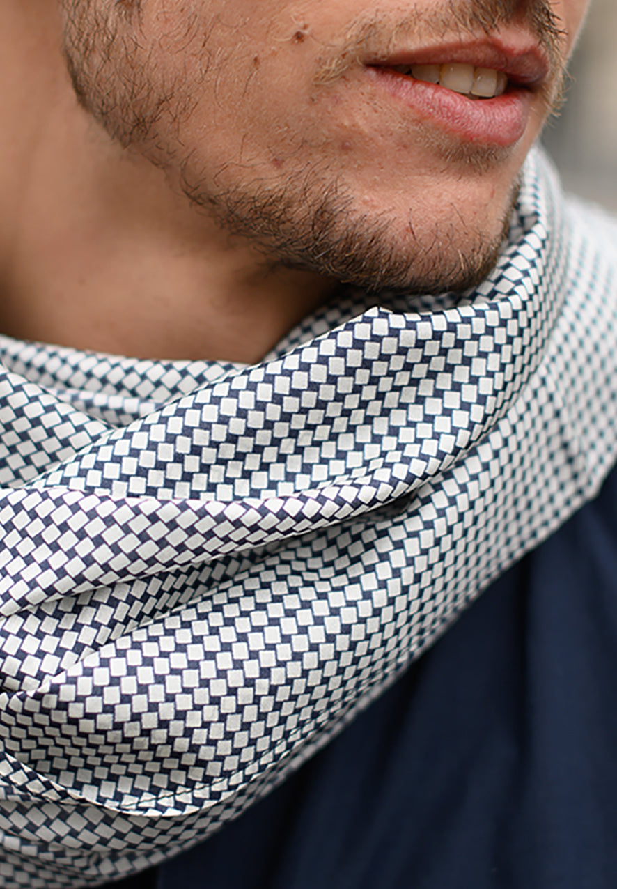 Foulard en soie 02, porté homme Meilleur Ami Paris. Imprimé cravate noir et blanc, vue en gros plan sur les motifs graphiques.