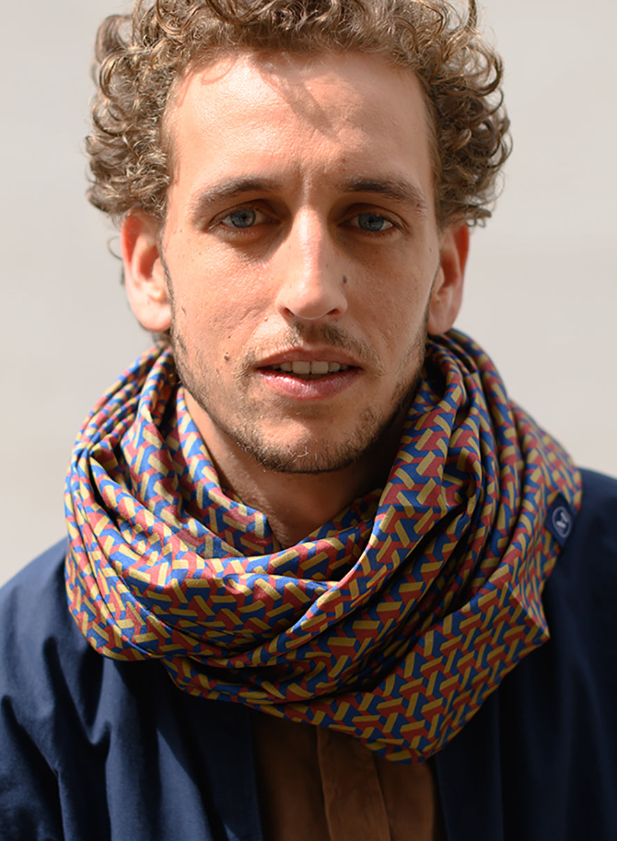 Foulard en soie 110 Meilleur Ami Paris, porté homme. Imprimé graphique effet 3D, coloris bordeaux, kaki et bleu.